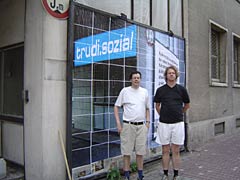 Stefan Beck and Mr. Braan in front of the poster